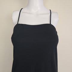 Black dress on a white mannequin against a beige background