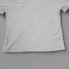 White t-shirt on a tiled floor