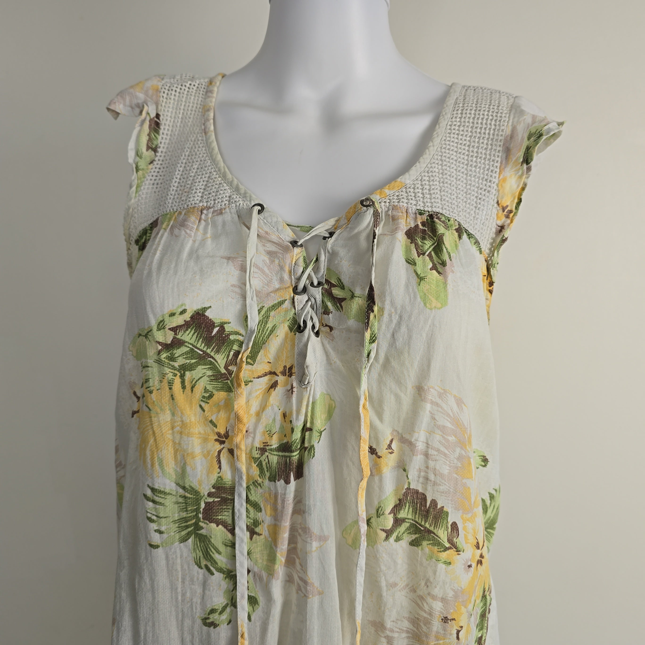 Mannequin wearing a sheer floral dress with a white background