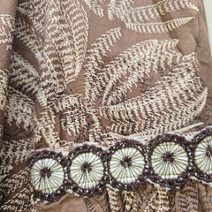 Textile with floral and circular patterns on a brown background
