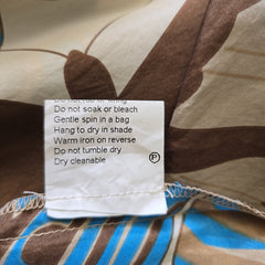 Clothing label with care instructions on a patterned fabric background