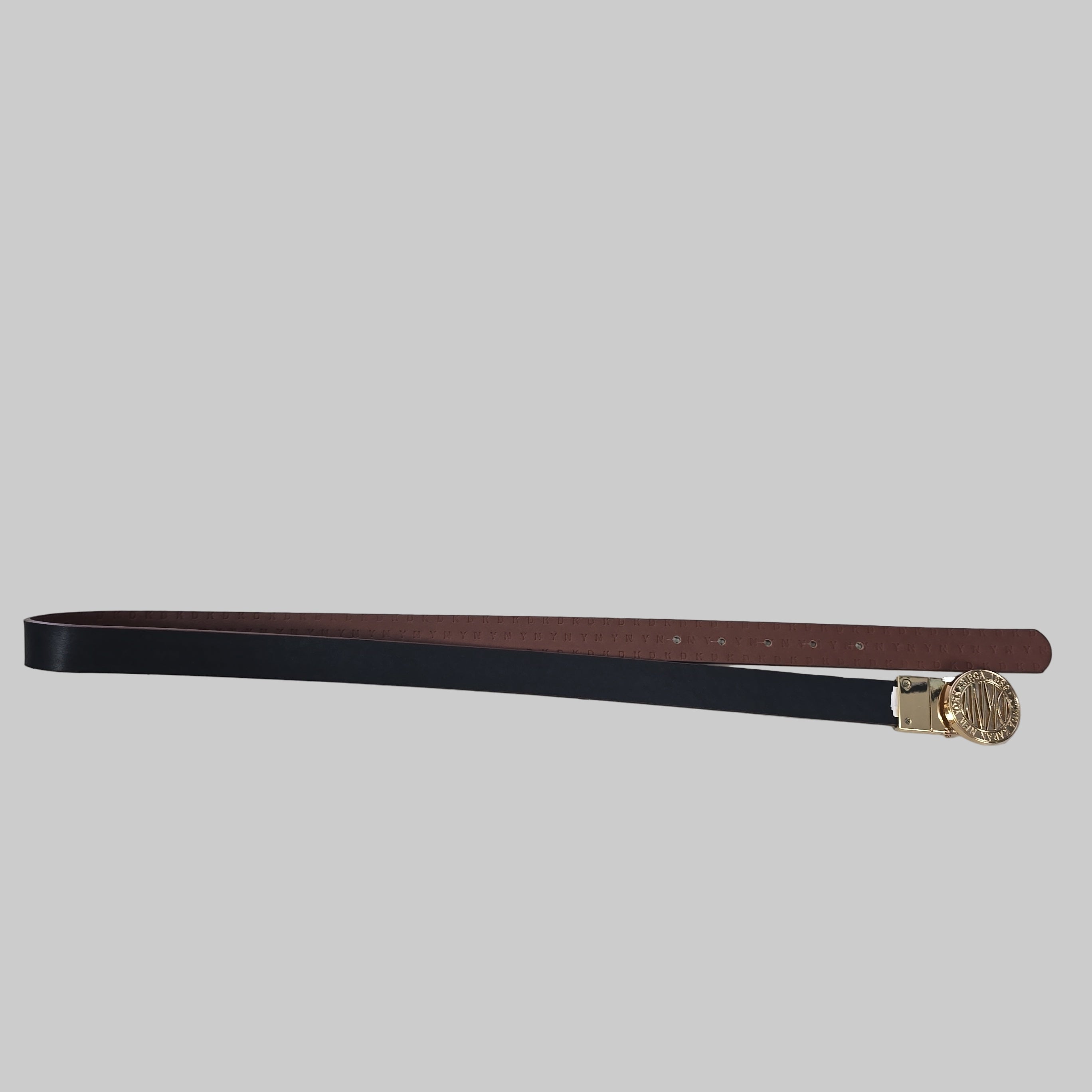 Black and brown belt with a gold buckle on a tiled floor