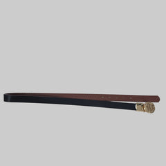 Black and brown belt with a gold buckle on a tiled floor
