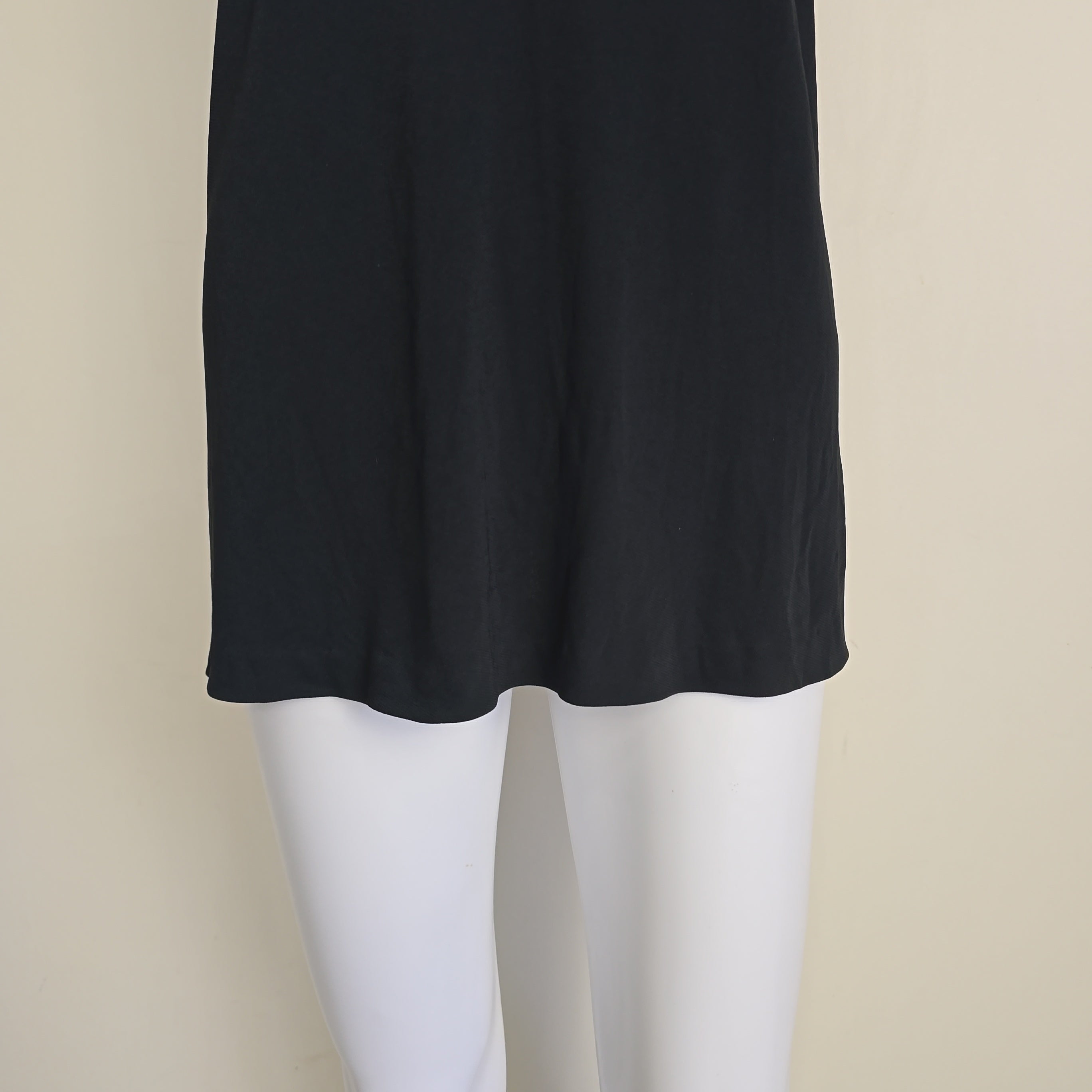 Black mini dress on a light background