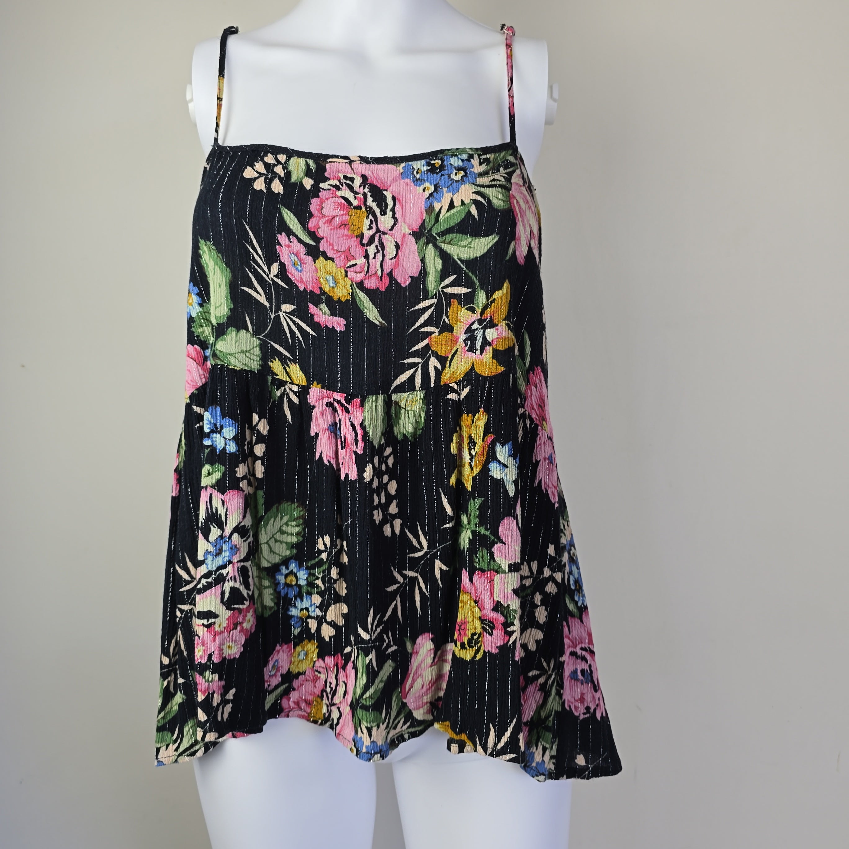 Black floral-patterned top on a light background