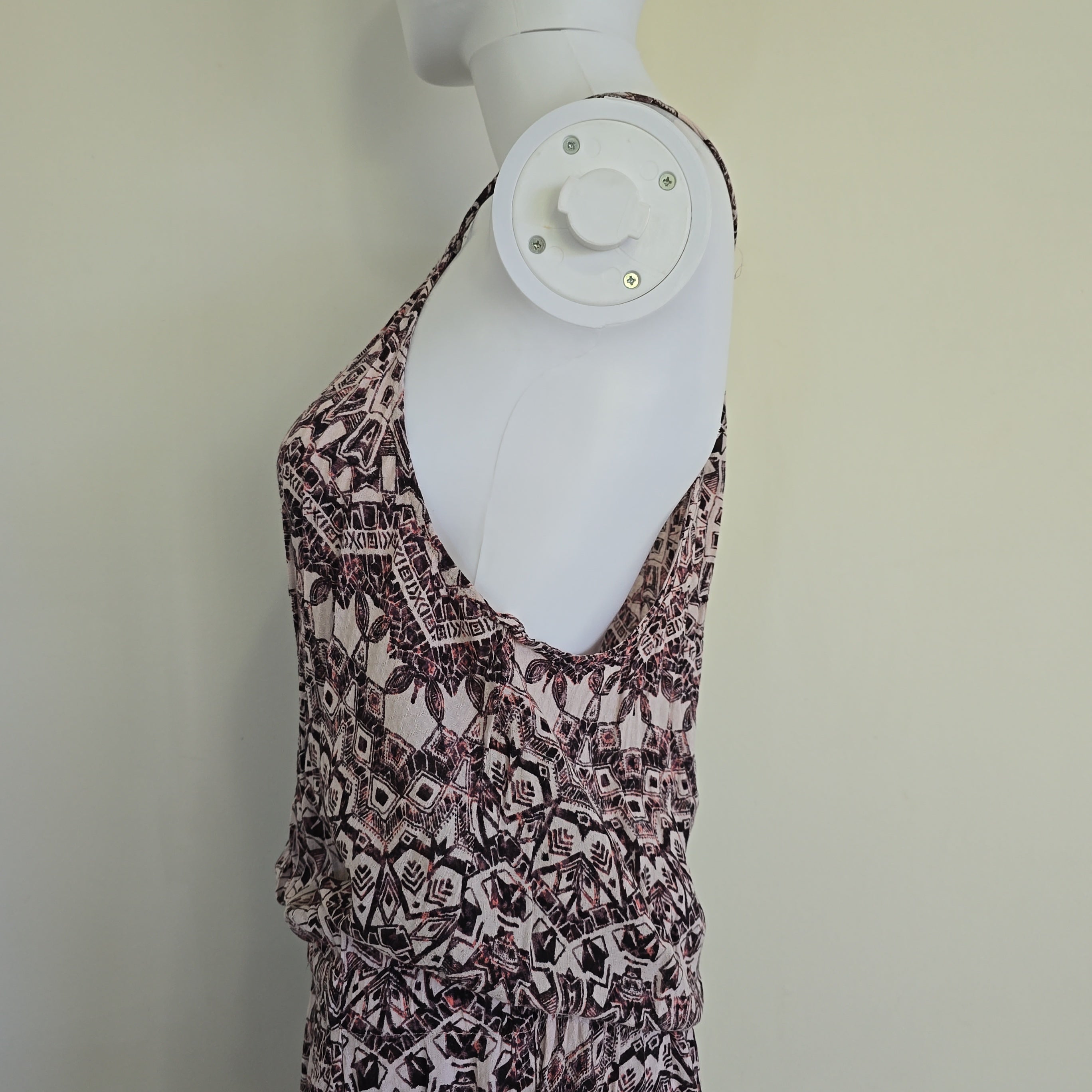 Patterned dress on a mannequin against a plain background