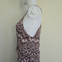 Patterned dress on a mannequin against a plain background
