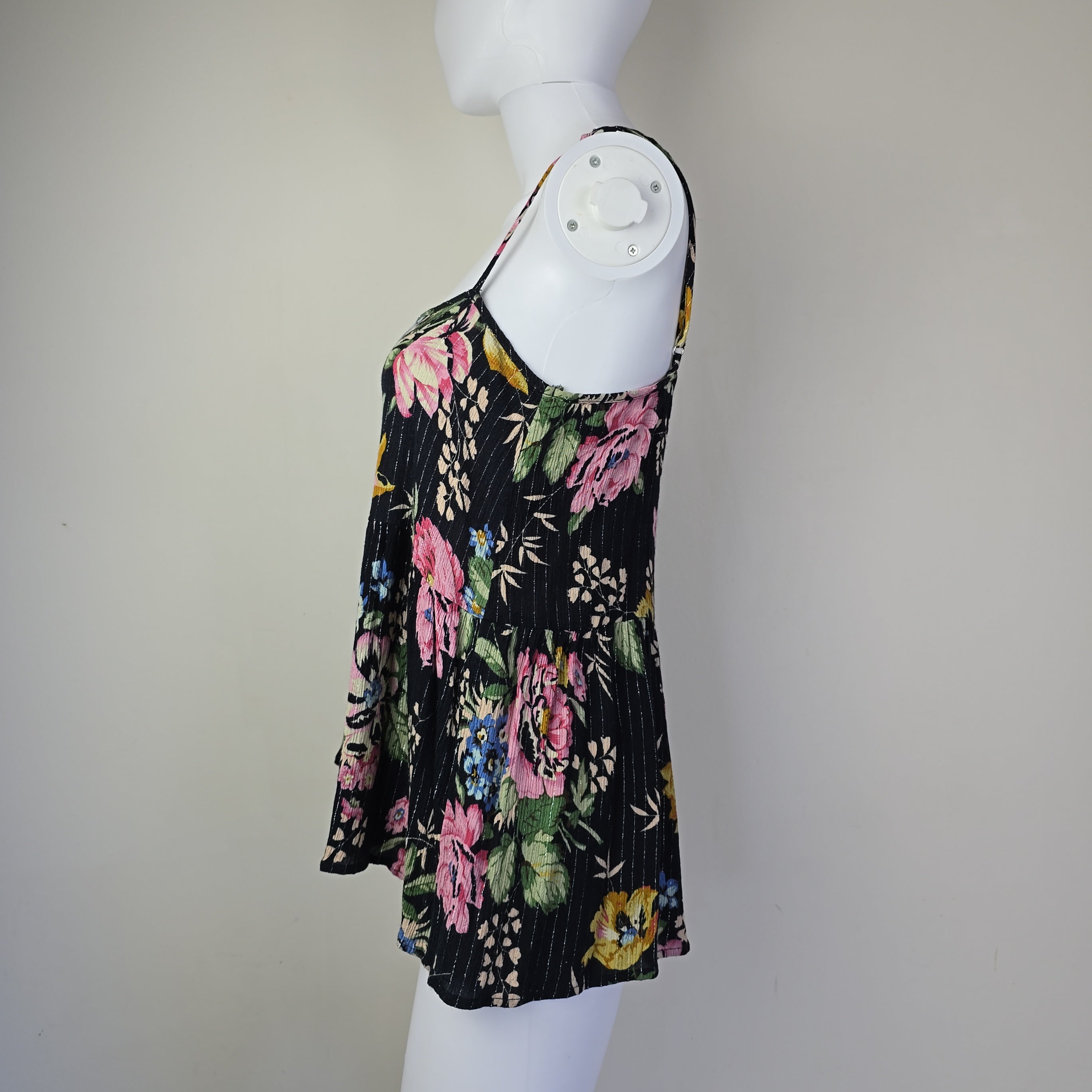 Black floral-patterned top on a light background