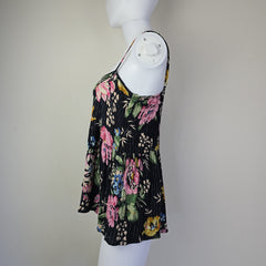 Black floral-patterned top on a light background