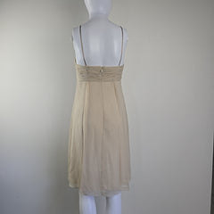 Beige dress on a mannequin against a plain background