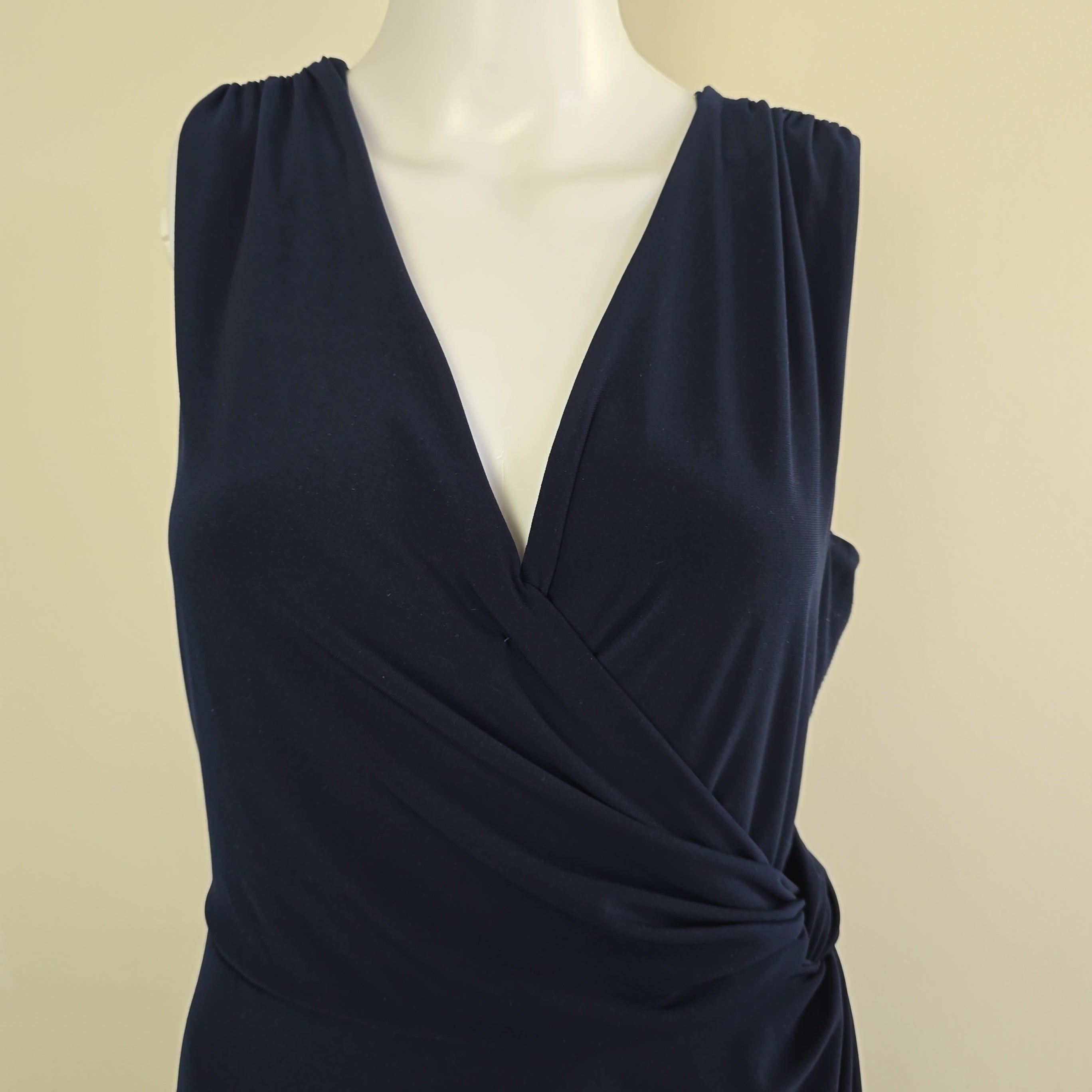 Navy blue dress on a light gray background