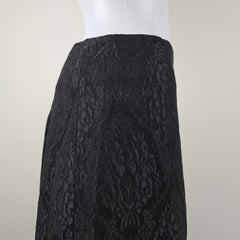 Black textured fabric skirt on a white background