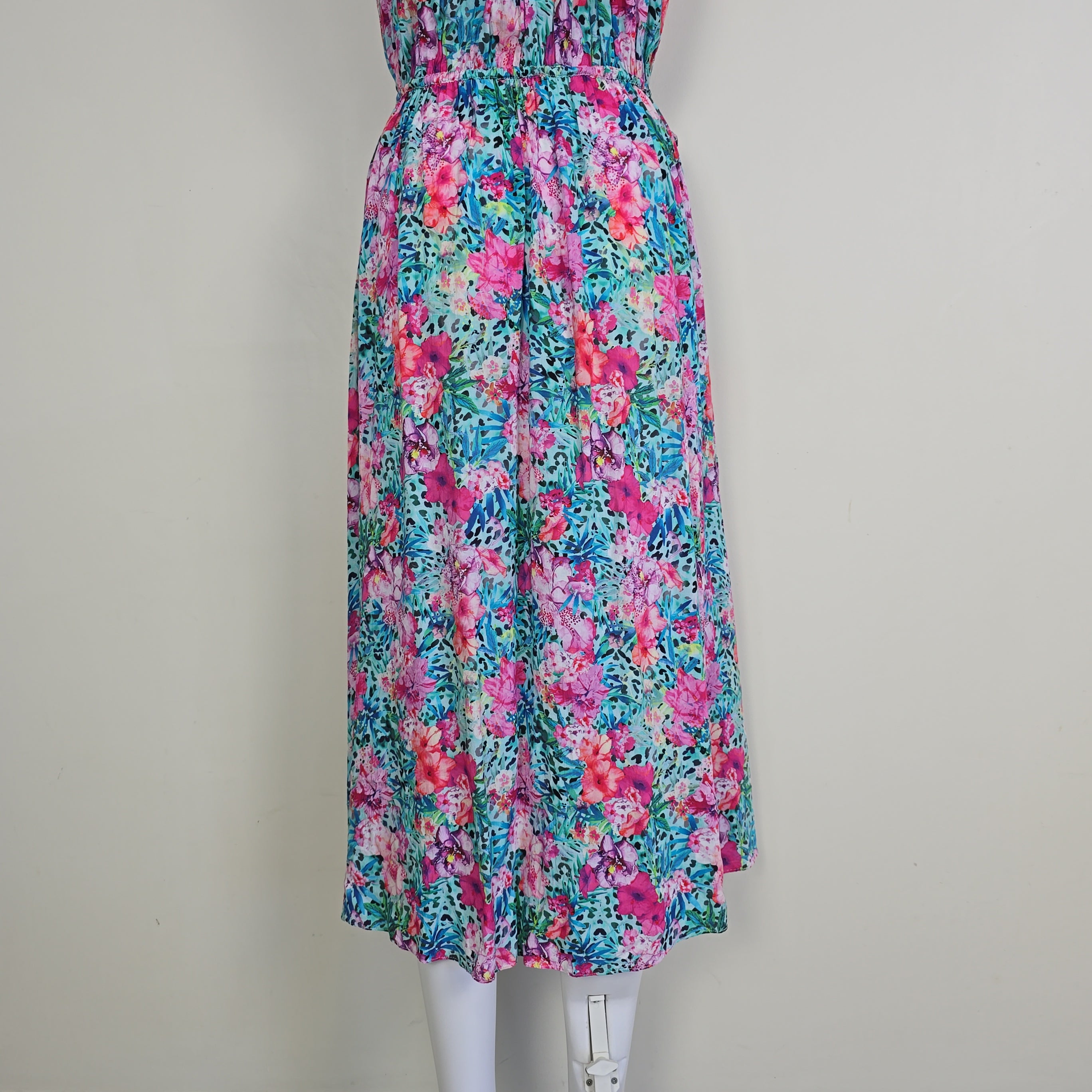 Folded floral dress with pink and blue pattern on a white background