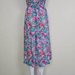 Folded floral dress with pink and blue pattern on a white background