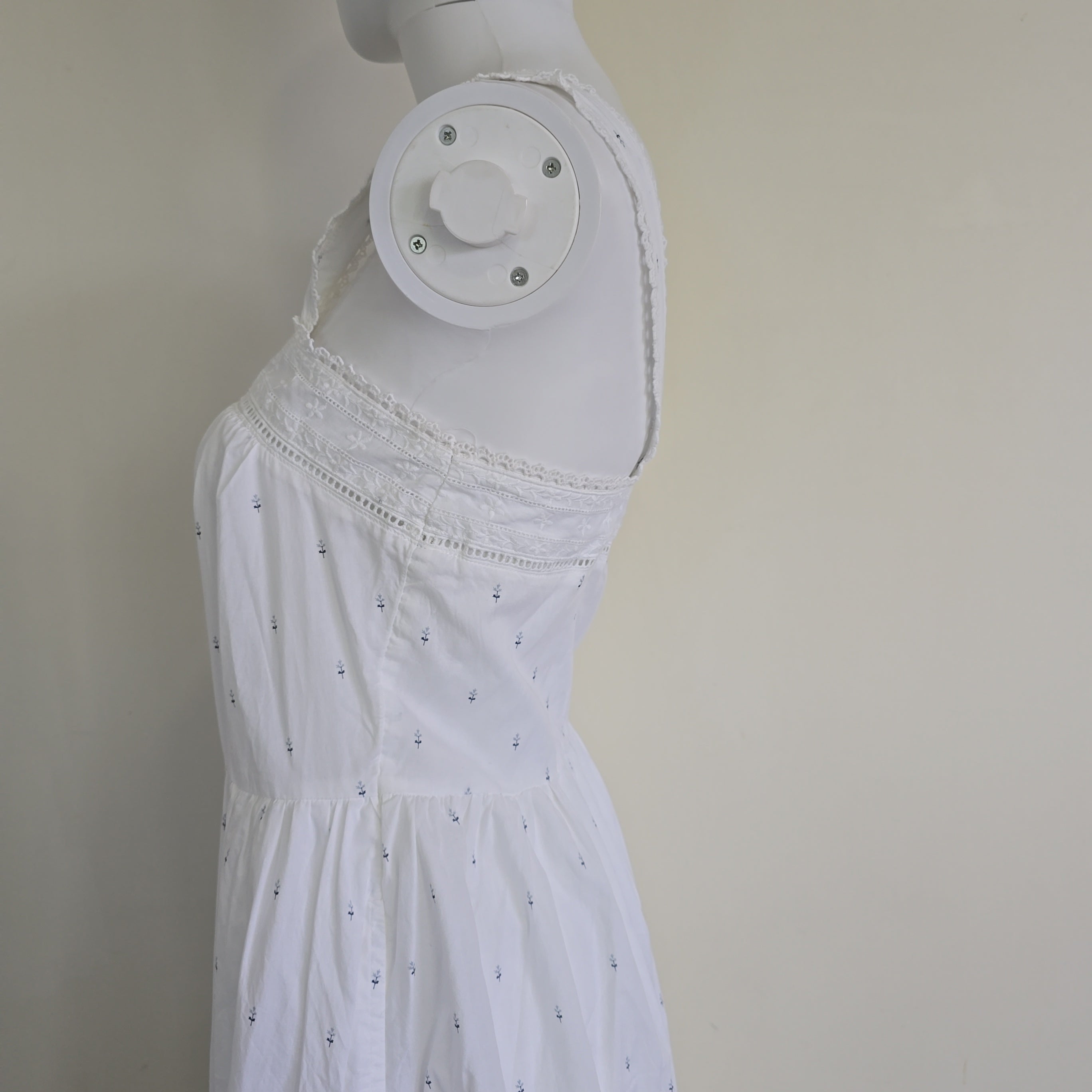 White dress on a mannequin against a plain background