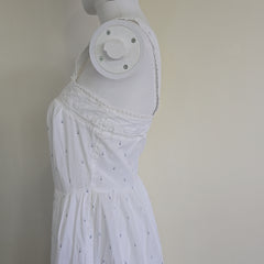 White dress on a mannequin against a plain background