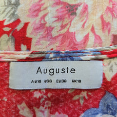 Floral fabric with a visible brand label on a multicolored background