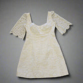 White lace dress on a tiled floor