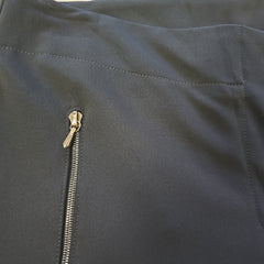 Close-up of a black pants with a gold zipper