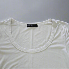 White tank top with a brand label on a tiled floor