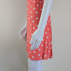 Red polka dot skirt on a mannequin against a plain background