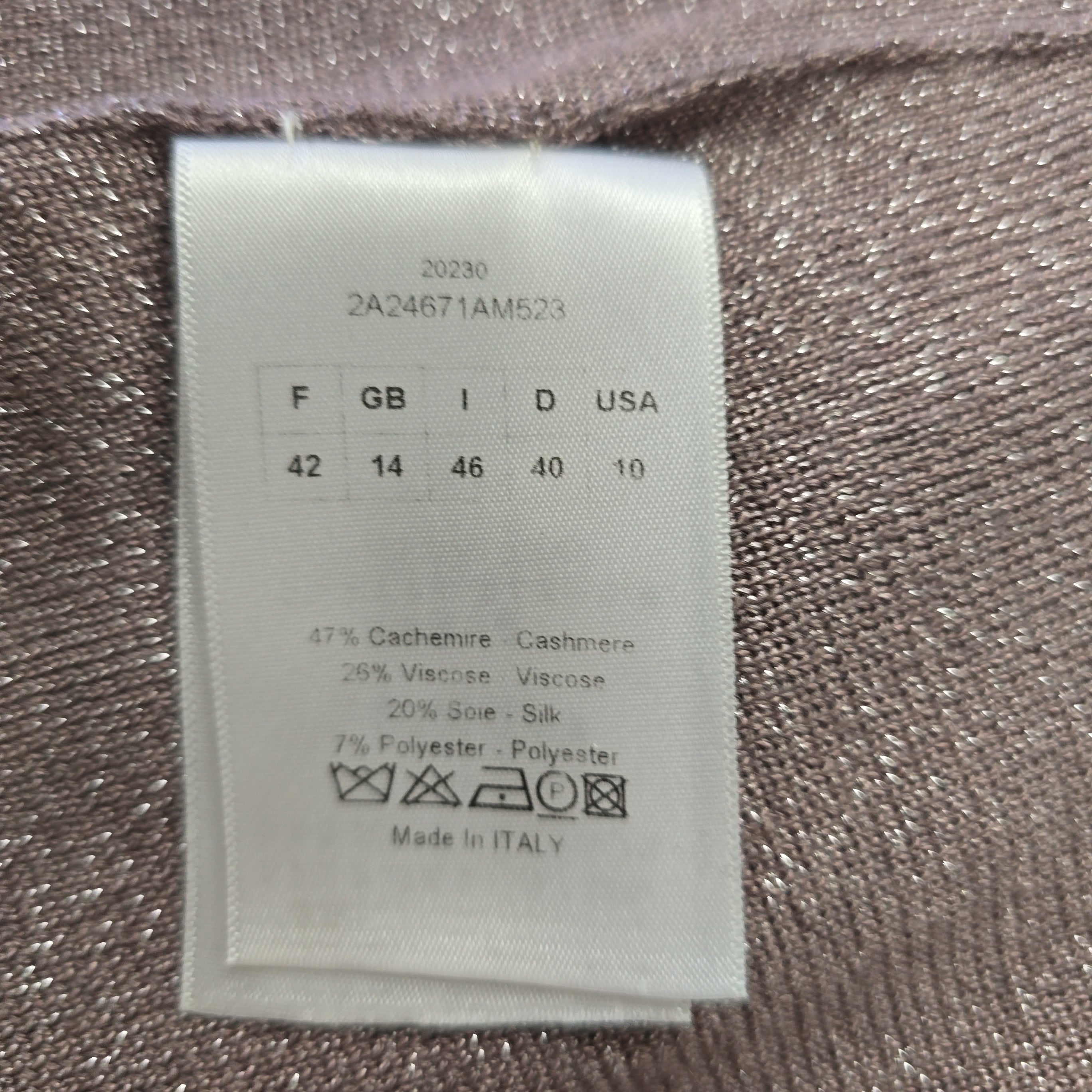 Fabric tag with size chart and material information on a textured fabric background