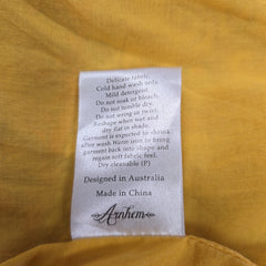 Clothing label on a yellow fabric background