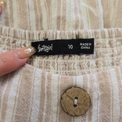 Fabric with a label and a button, showing 'made in China' and 'sportsgirl' branding.