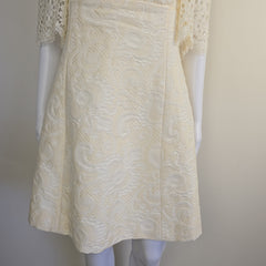 White textured fabric on a mannequin with a plain background