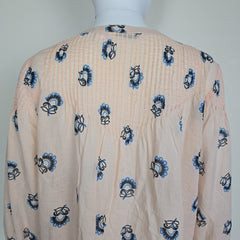 Beige fabric with blue and black floral patterns on a white background