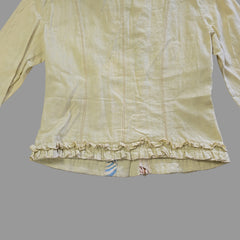 Light yellow jacket with frill details on a light background