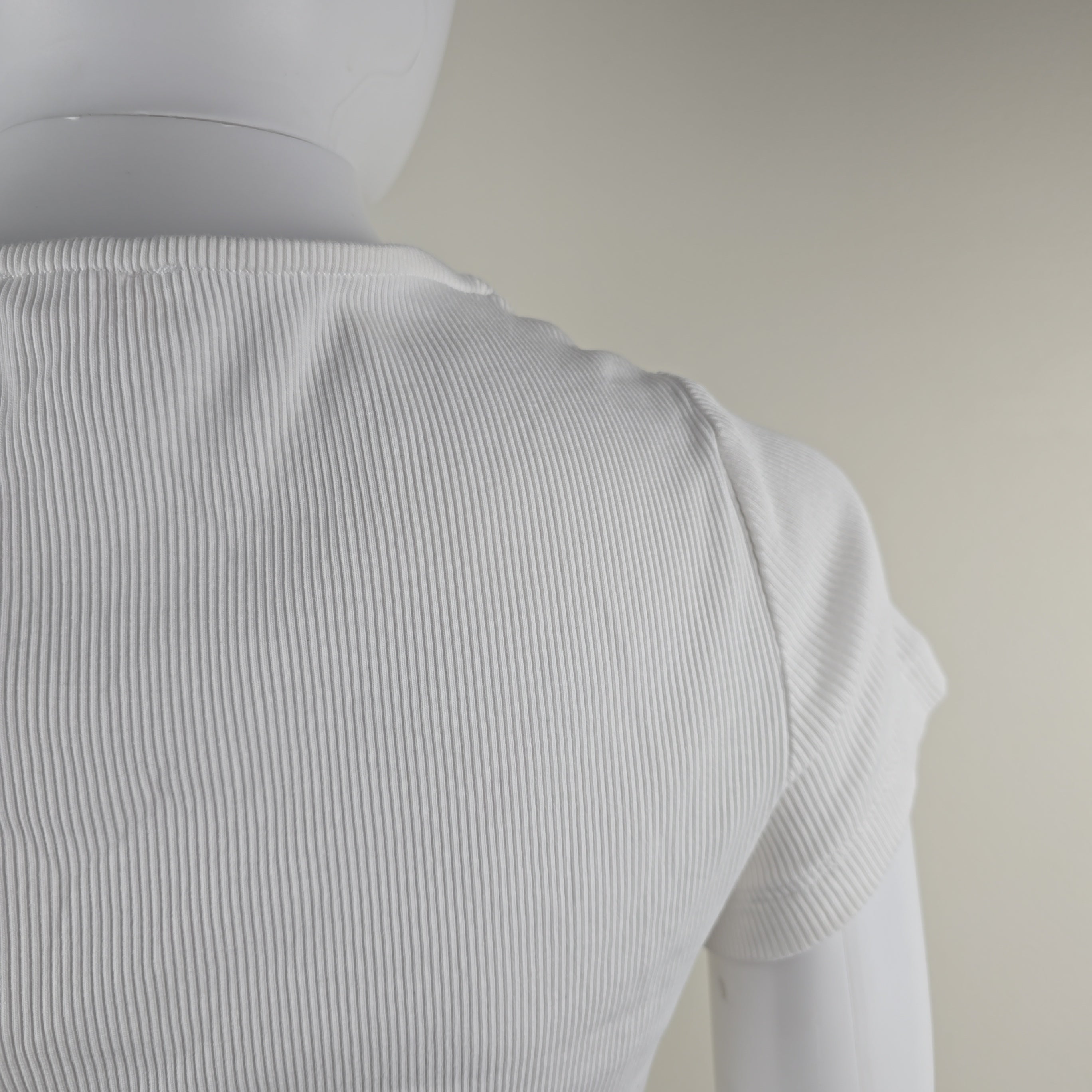 Close-up of a textured white fabric on a neutral background