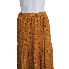 Brown patterned fabric on a mannequin against a plain background