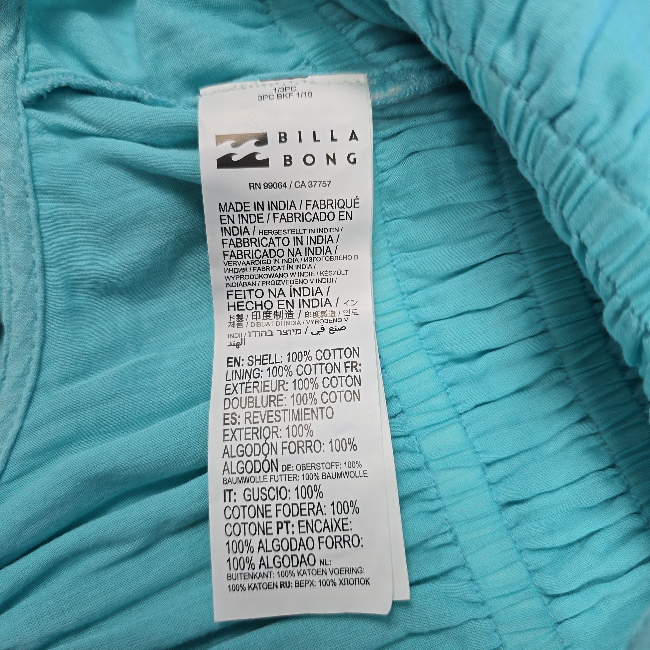Close-up of a Billabong label on a turquoise fabric background