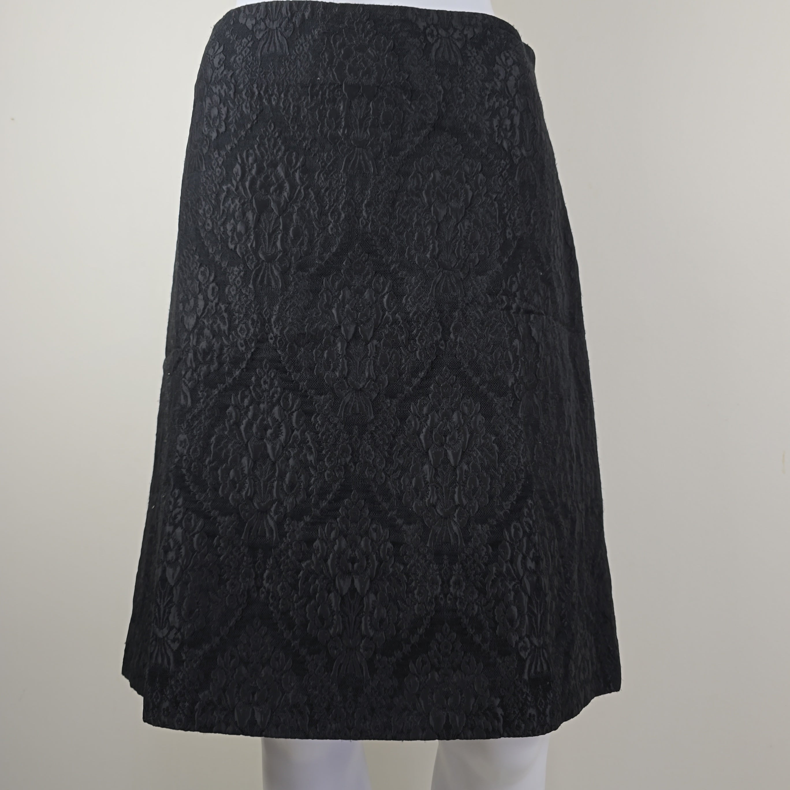 Black textured skirt on a light gray background