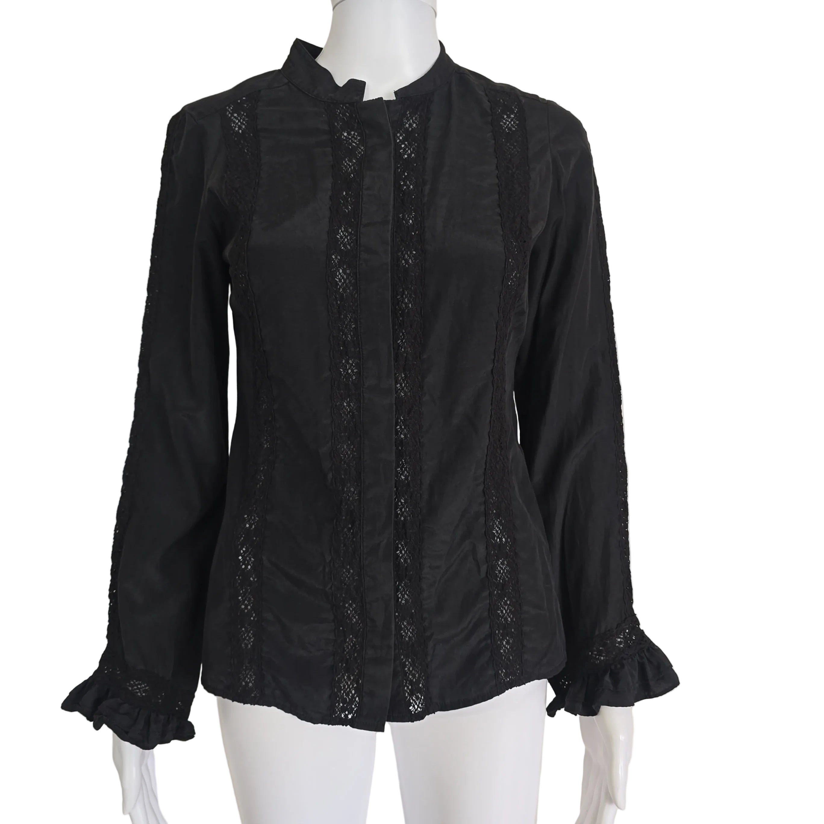 Black lace-trimmed garment on a mannequin against a beige background