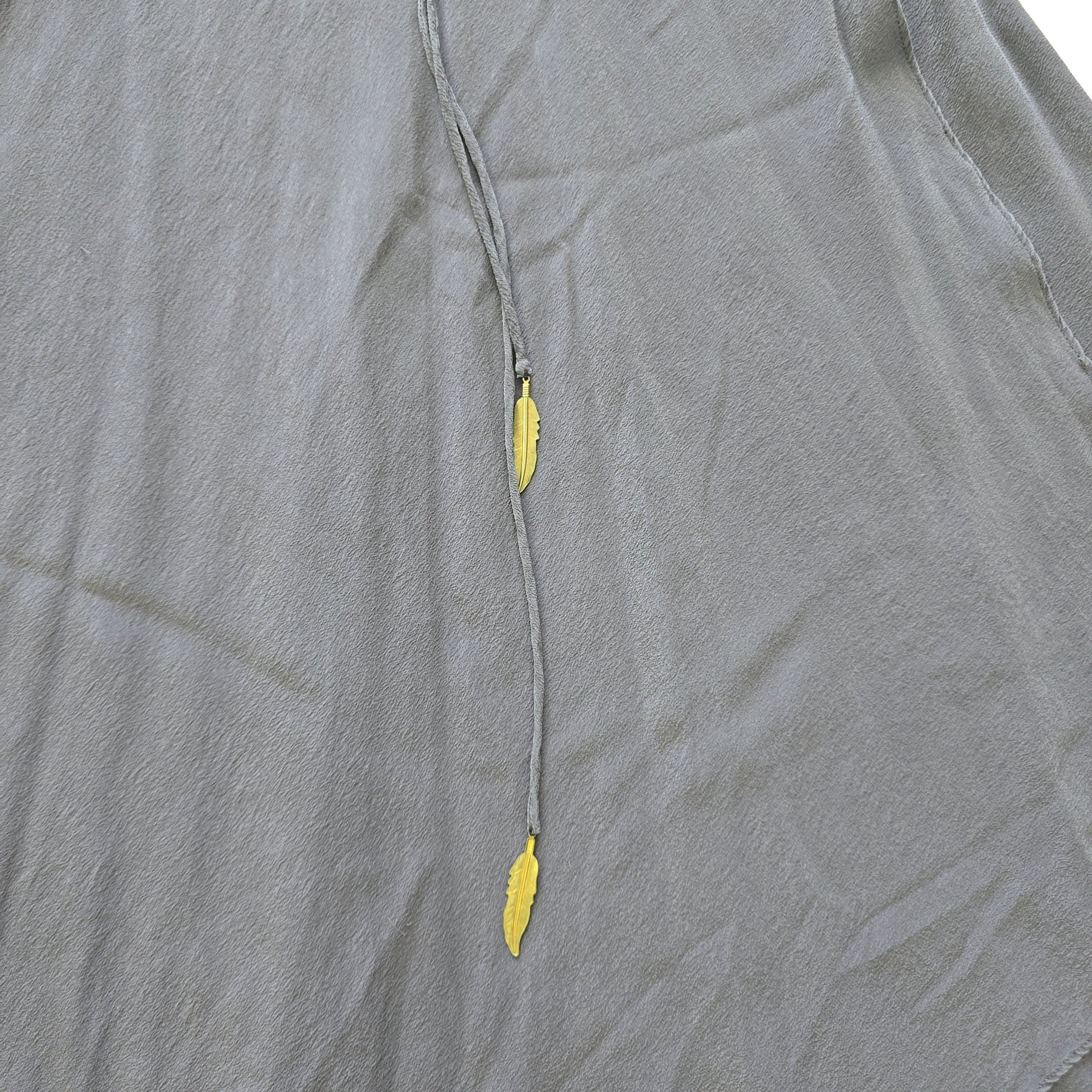 Gray fabric with gold leaf beads on a gray background