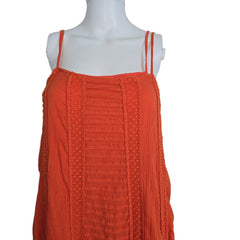 Orange dress on a mannequin against a plain background