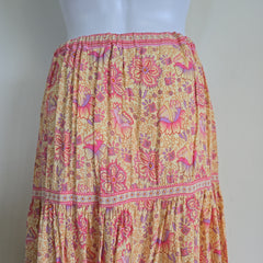Mannequin wearing a floral skirt with pink and orange patterns on a white background