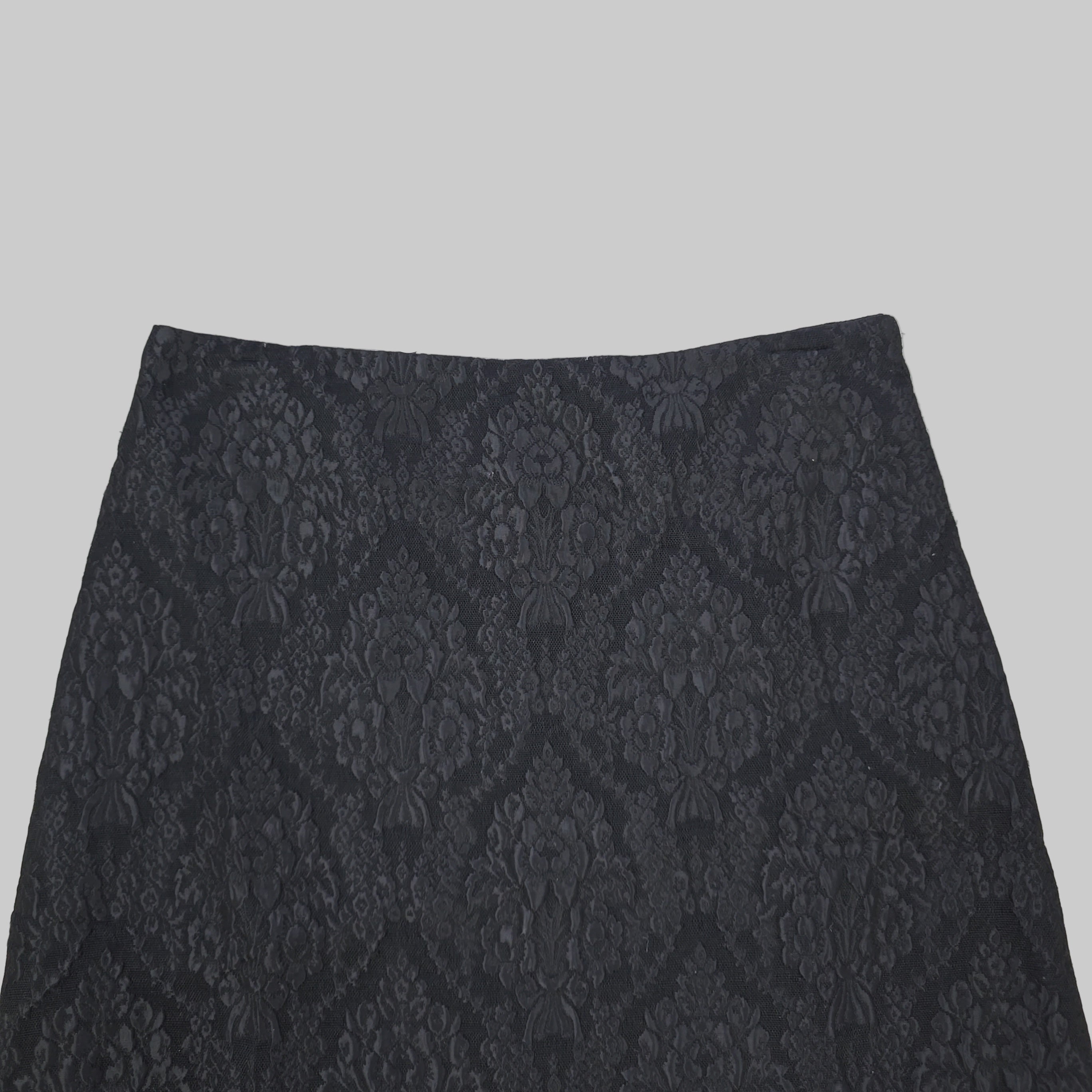 Black lace skirt on a tiled floor