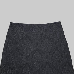 Black lace skirt on a tiled floor