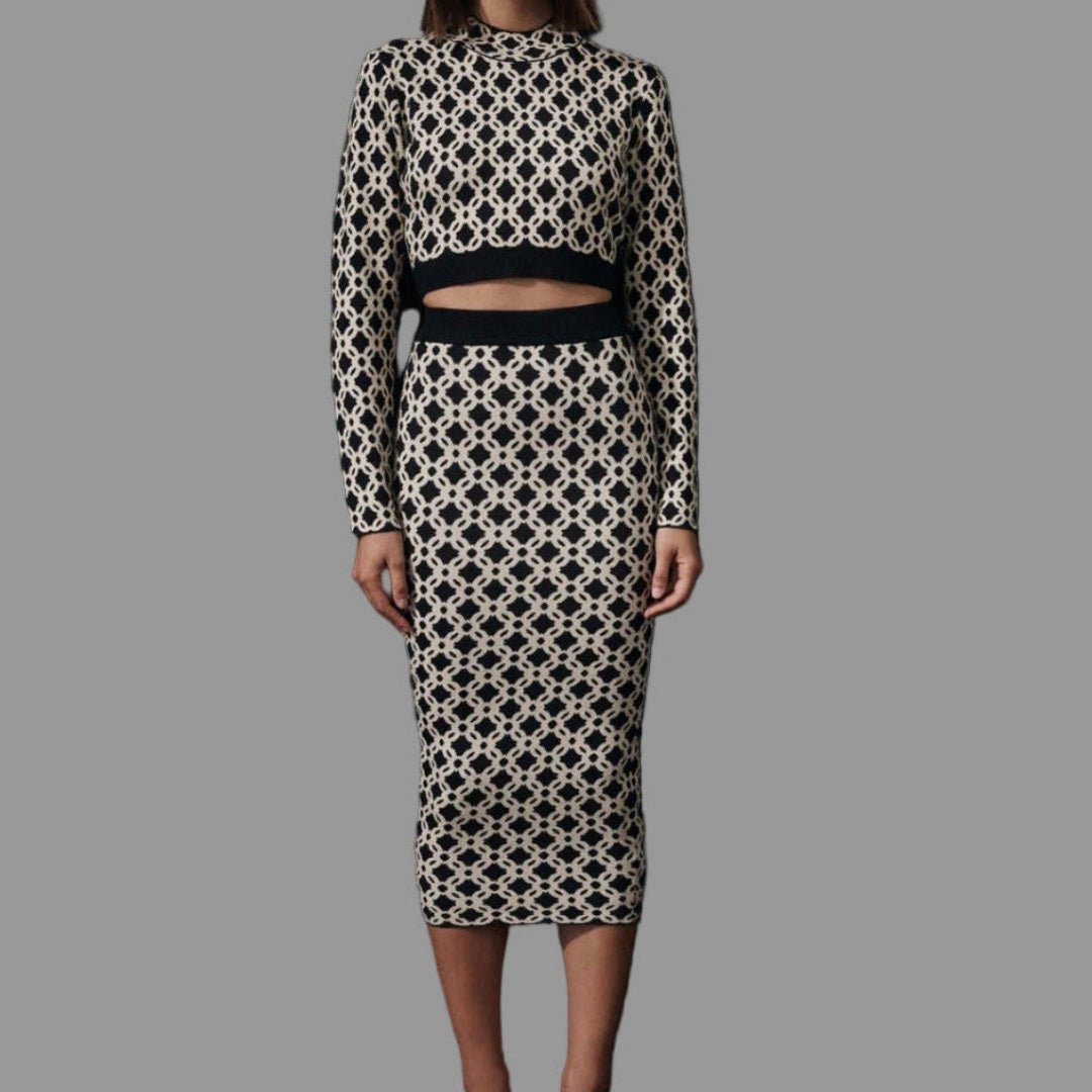 Woman wearing a black and white patterned outfit on a black background