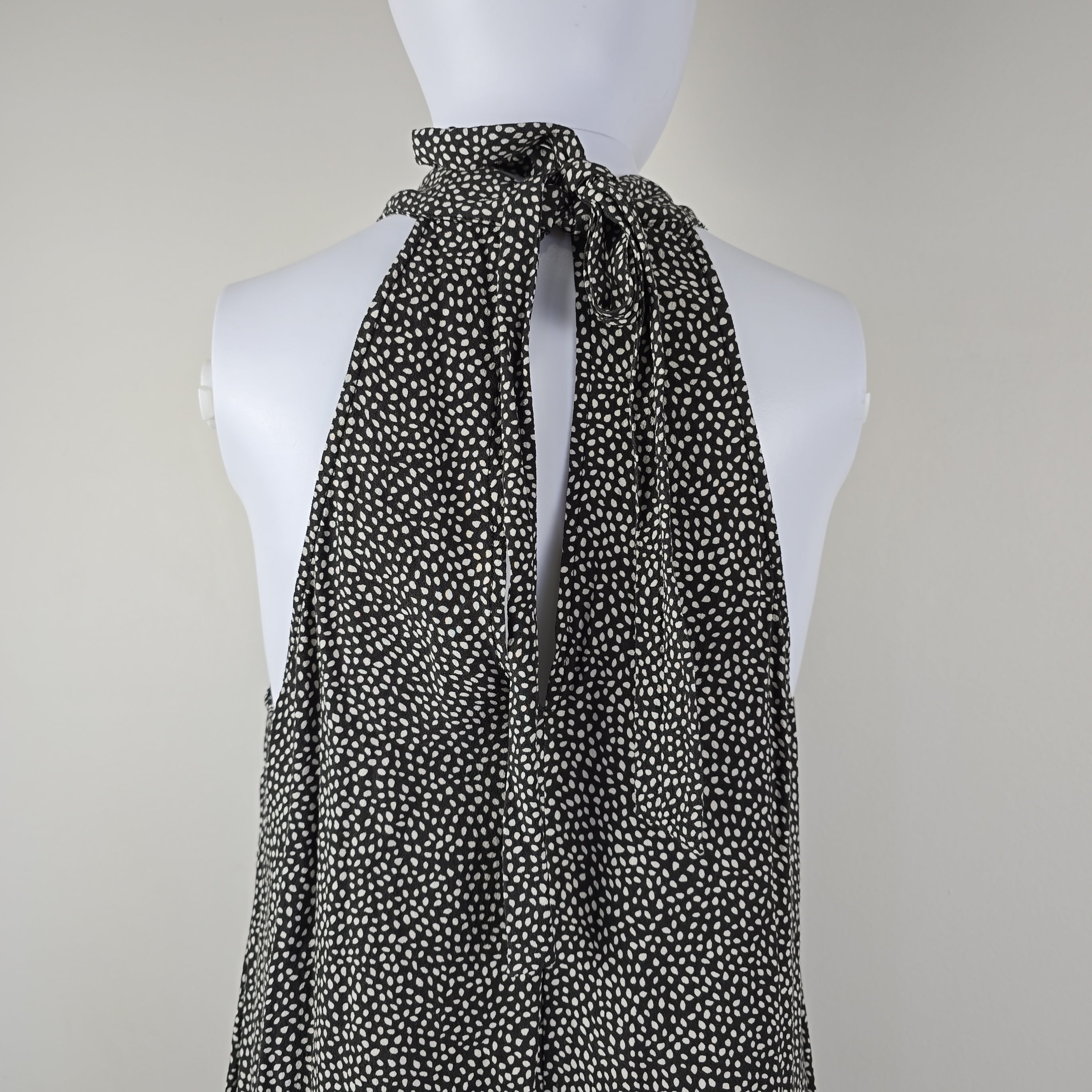 Grey and white spotted patterned dress on a light background