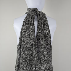 Grey and white spotted patterned dress on a light background