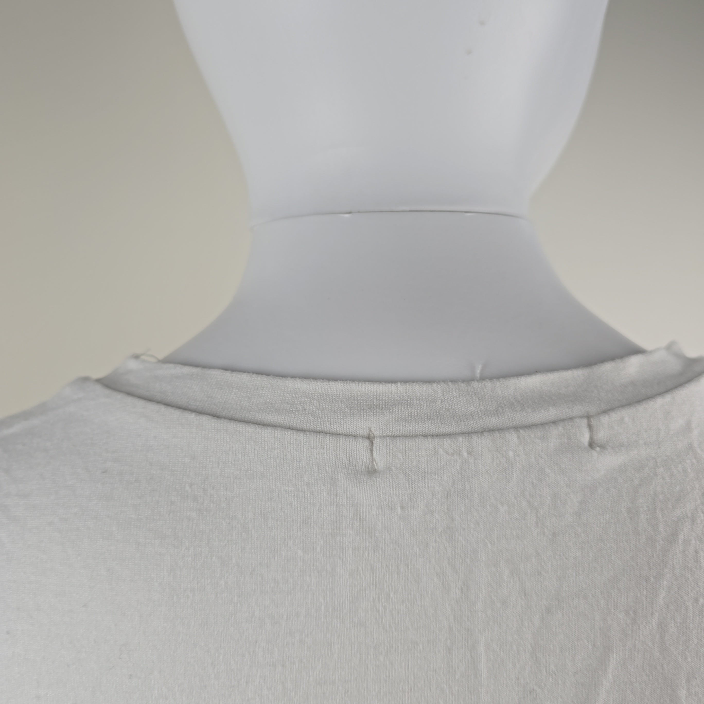 Gray topon a mannequin against a neutral background