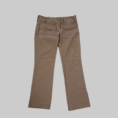 Brown pants on a white tiled floor