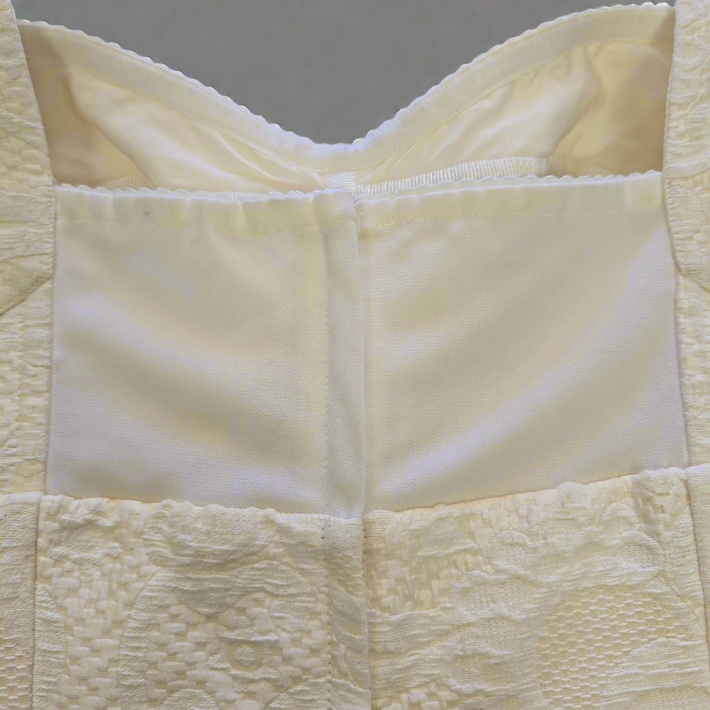 Close-up of a textured beige fabric with a checkered pattern
