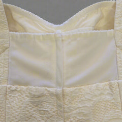 Close-up of a textured beige fabric with a checkered pattern