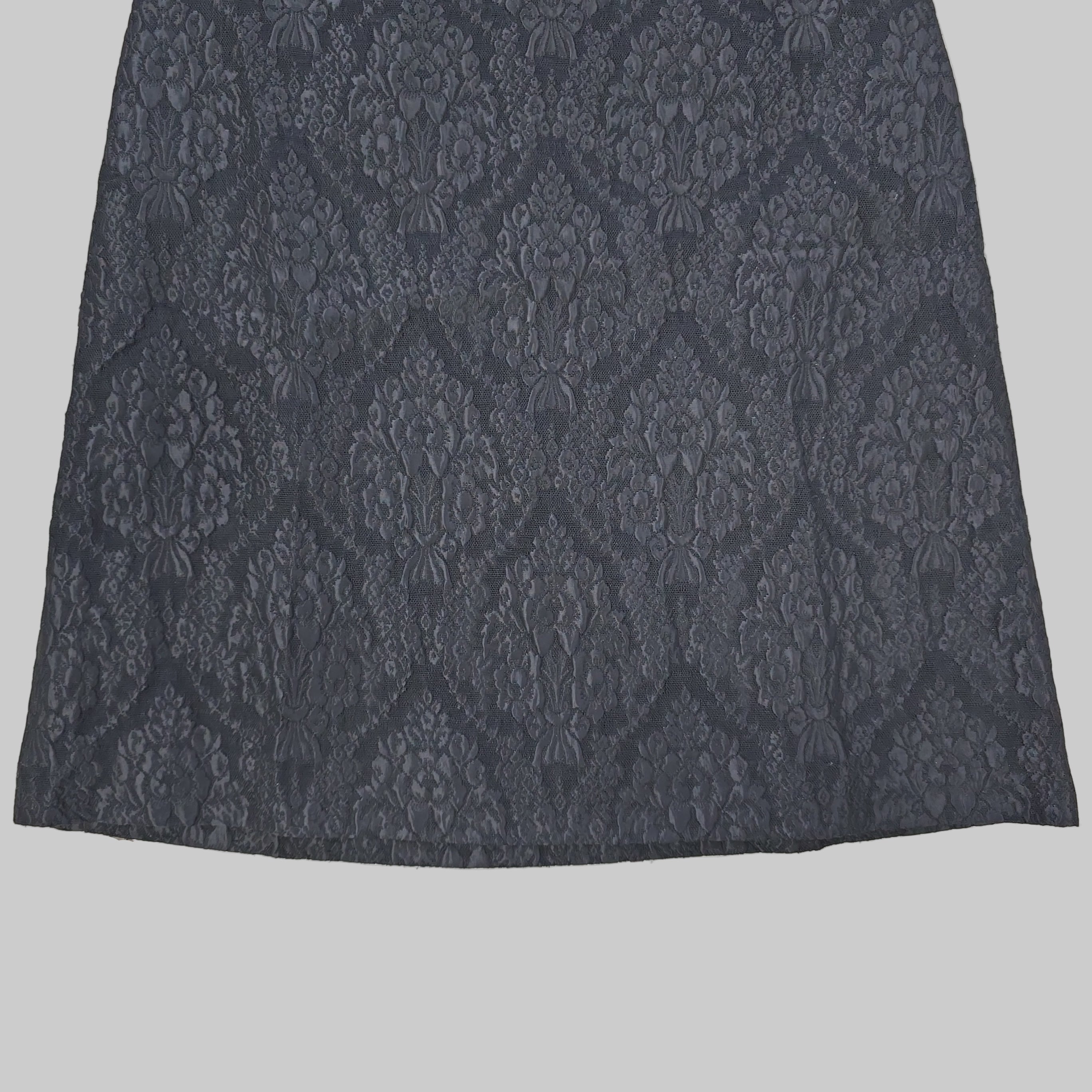 Black skirt on a tiled floor