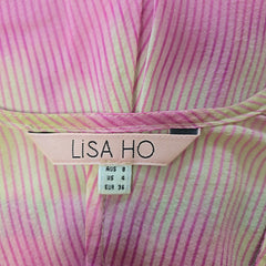 Close-up of a pink and yellow striped garment with a Lisa Ho label.